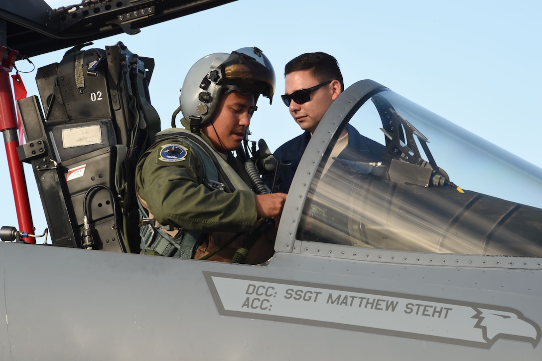 U.S. Air Force Capt. Christopher Lacroix, 194th Fighter Squadron pilot, California Air National Guard, performs pre-flight checks in an F-15C Eagle assisted by his crew chief, Staff Sgt. Michael Pruitt, March 30, 2017 during Sentry Aloha 17-03. Sentry Aloha is an Air Guard led exercise that provides a current, realistic, and integrated training environment to the U.S. Air Force and joint partners. (Air National Guard photo by Senior Master Sgt. Chris Drudge)