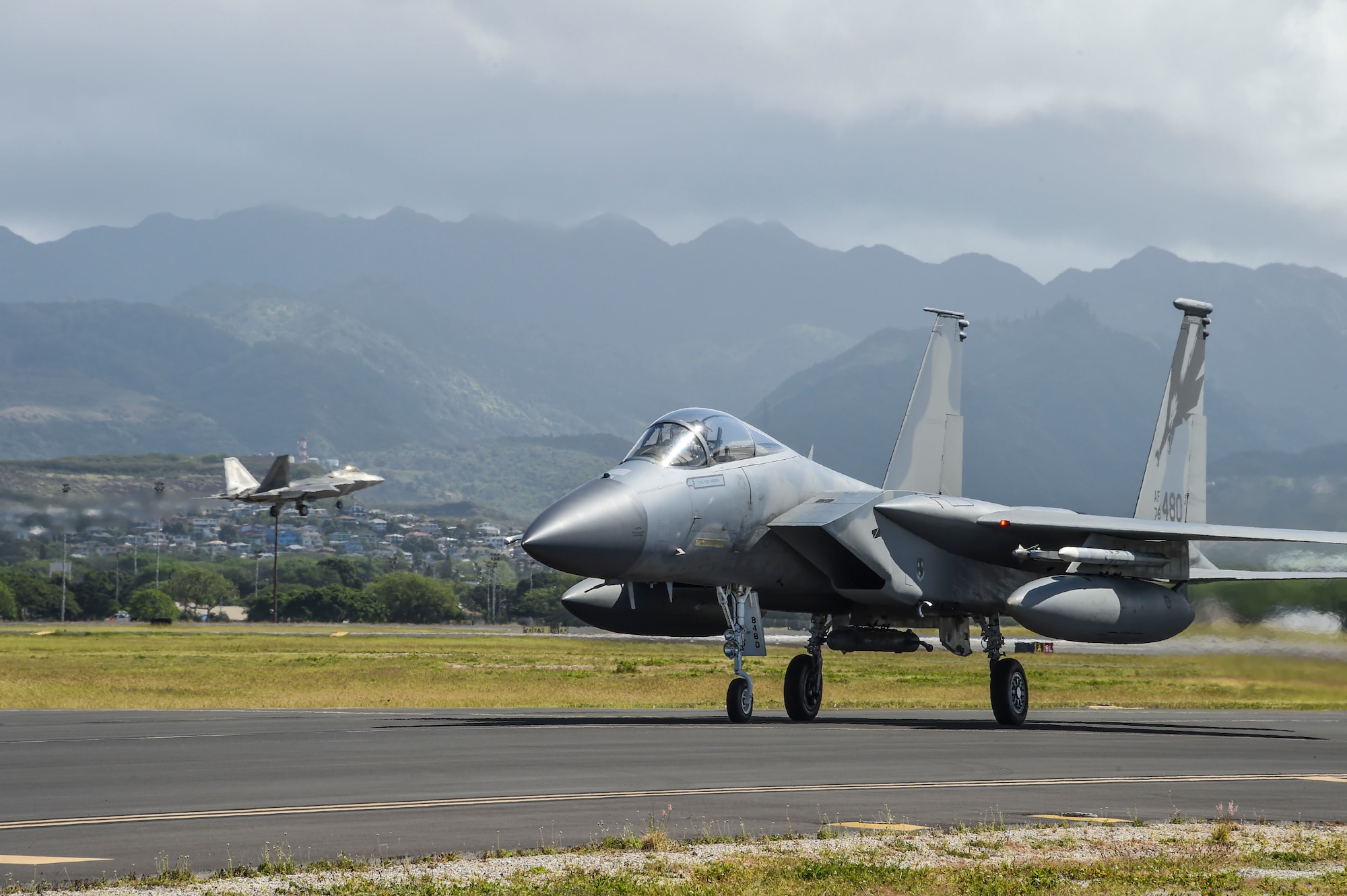 A U.S. Air Force F-15 Eagle from the California Air National Guard’s 144th Fighter Wing and an F-22 Raptor from the 154th Wing’s Hawaii Air National Guard return to Joint Base Pearl Harbor-Hickam after the morning sortie at the Honolulu International Airport April 1, 2017 during Sentry Aloha 17-03. Sentry Aloha provides the ANG, Air Force and DoD counterparts a multi-faceted, joint venue with supporting infrastructure and personnel that incorporates current, realistic integrated training. (Air National Guard photo by Senior Master Sgt. Chris Drudge)