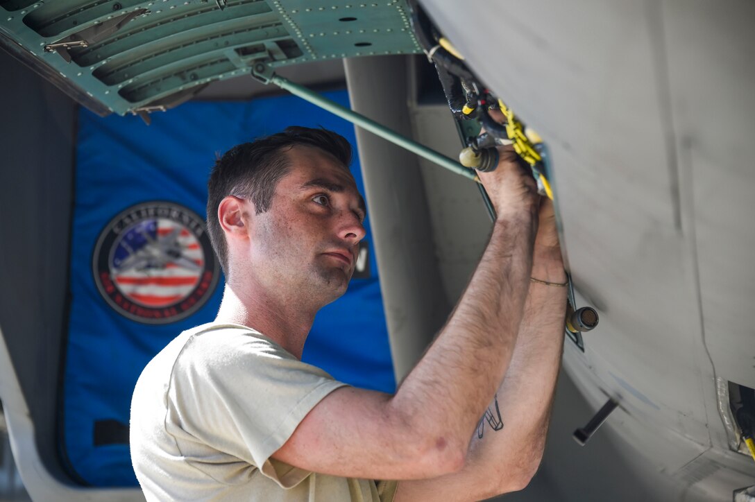 U.S. Air Force Senior Airman Grant Georgeson, 144th Aircraft Maintenance Squadron avionics section, California Air National Guard, installs a fuel quantity signal conditioner on an F-15C Eagle during Sentry Aloha 17-03 April 5, 2017. Sentry Aloha is an Air Guard led exercise that provides a current, realistic, and integrated training environment to the U.S. Air Force and joint partners. (Air National Guard photo by Senior Master Sgt. Chris Drudge)