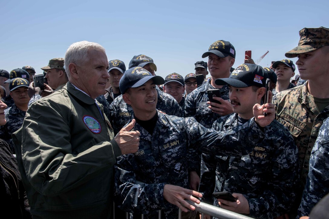 Vice President Mike Pence poses for a photo with a sailor on the flight deck of the USS Ronald Reagan in Yokosuka, Japan, April 19, 2017. Navy photo by Petty Officer 2nd Class Nathan Burke