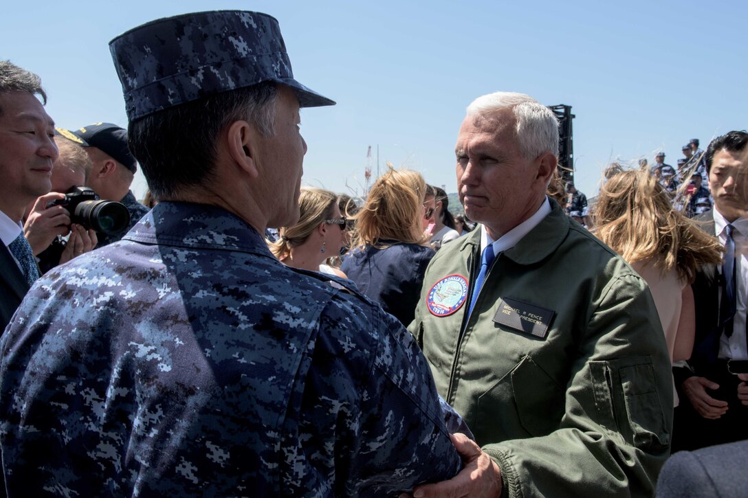 Vice President Mike Pence shakes hands with Japan Maritime Self-Defense Force Vice Adm. Seiichi Doman, Yokosuka District commandant, on the flight deck of the USS Ronald Reagan in Yokosuka, Japan, April 19, 2017. Navy photo by Petty Officer 2nd Class Nathan Burke
