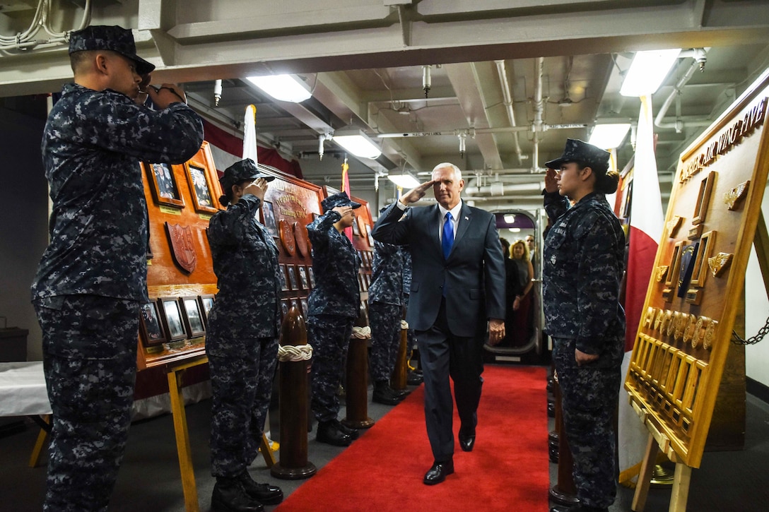 Vice President Mike Pence salutes sailors upon arriving aboard the forward-deployed aircraft carrier USS Ronald Reagan in Yokosuka, Japan, April 19, 2017. The vice president’s tour of the ship and his remarks to U.S. and Japanese service members highlighted the administration’s continuing commitment to rebuilding the military and to its alliances in the region. The Ronald Reagan, the flagship of Carrier Strike Group 5, provides a combat-ready force that protects and defends the collective maritime interests of allies and partners in the Indo-Asia-Pacific region. Navy photo by Petty Officer 2nd Class Nathan Burke