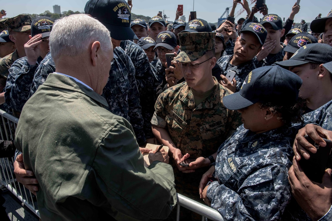 Vice President Mike Pence signs an autograph for a service member on the flight deck of the USS Ronald Reagan in Yokosuka, Japan, April 19, 2017. Navy photo by Petty Officer 2nd Class Nathan Burke