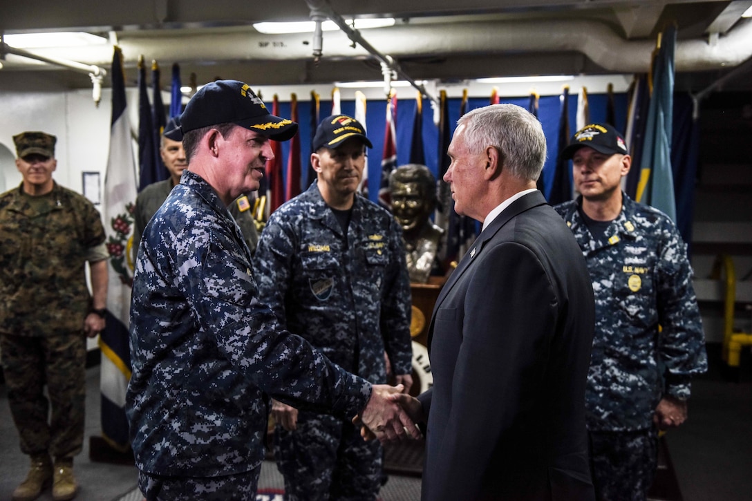 Vice President Mike Pence exchanges greetings with Navy Capt. Michael "Buzz" Donnelly, commanding officer of the USS Ronald Reagan, on the ship’s ceremonial quarterdeck in Yokosuka, Japan, April 19, 2017. Navy photo by Petty Officer 2nd Class Nathan Burke