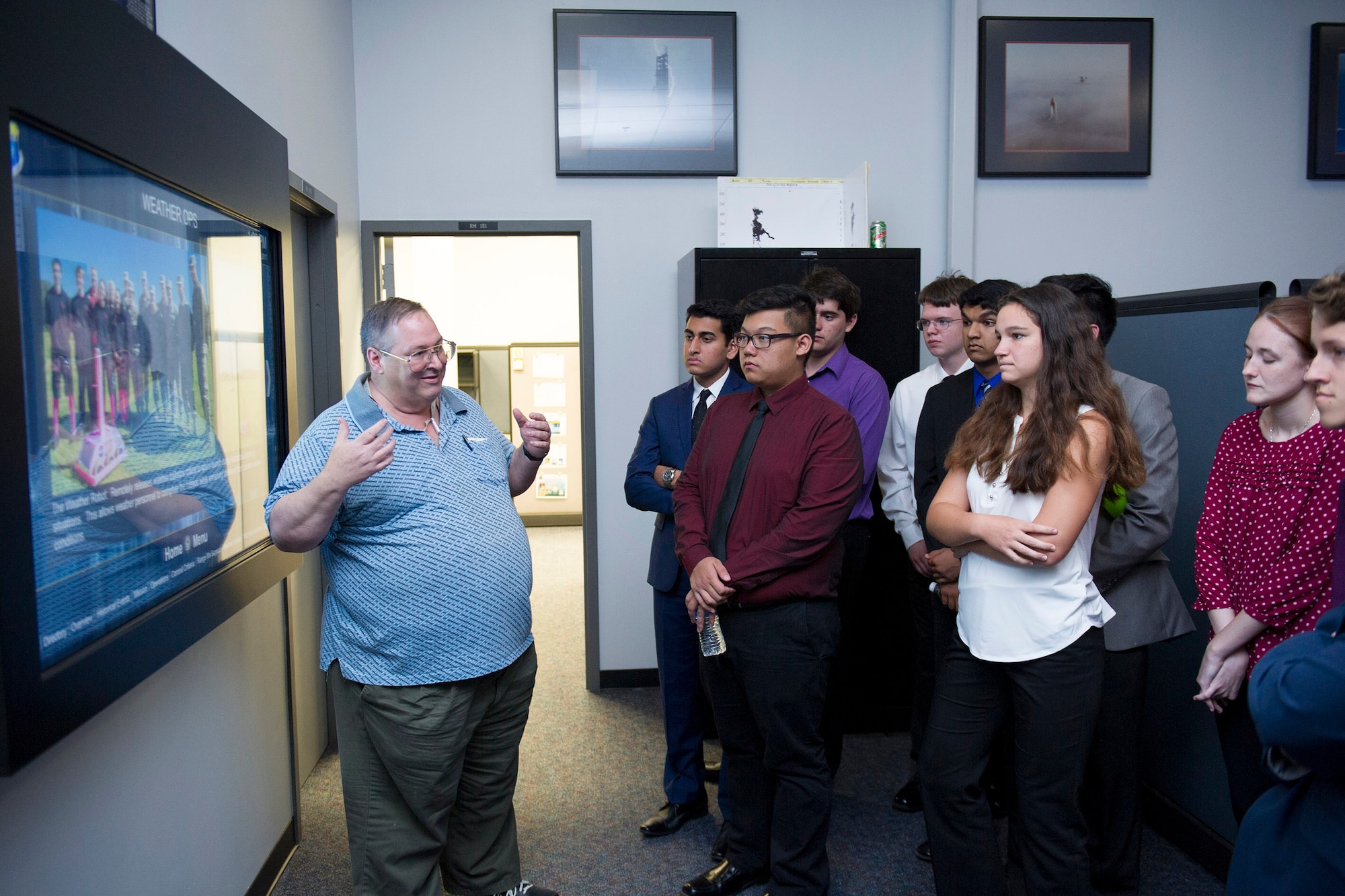 William Roeder, 45th Weather Squadron meteorologist, gives Lake Nona High School students a tour of the Morrell Operations Center April 18, 2017, at Cape Canaveral Air Force Station, Fla. Members of the 45th WS met with students to discuss their Lightning Launch Commit Criteria findings and results in regards to weather and climatology. Prior to the school year, Roeder reached out to the high school and introduced them to the project. The project provides students with real-world experience by following a business model of preparation, set-up, and using innovative methods to complete it. (U.S. Air Force photo by Phil Sunkel)  