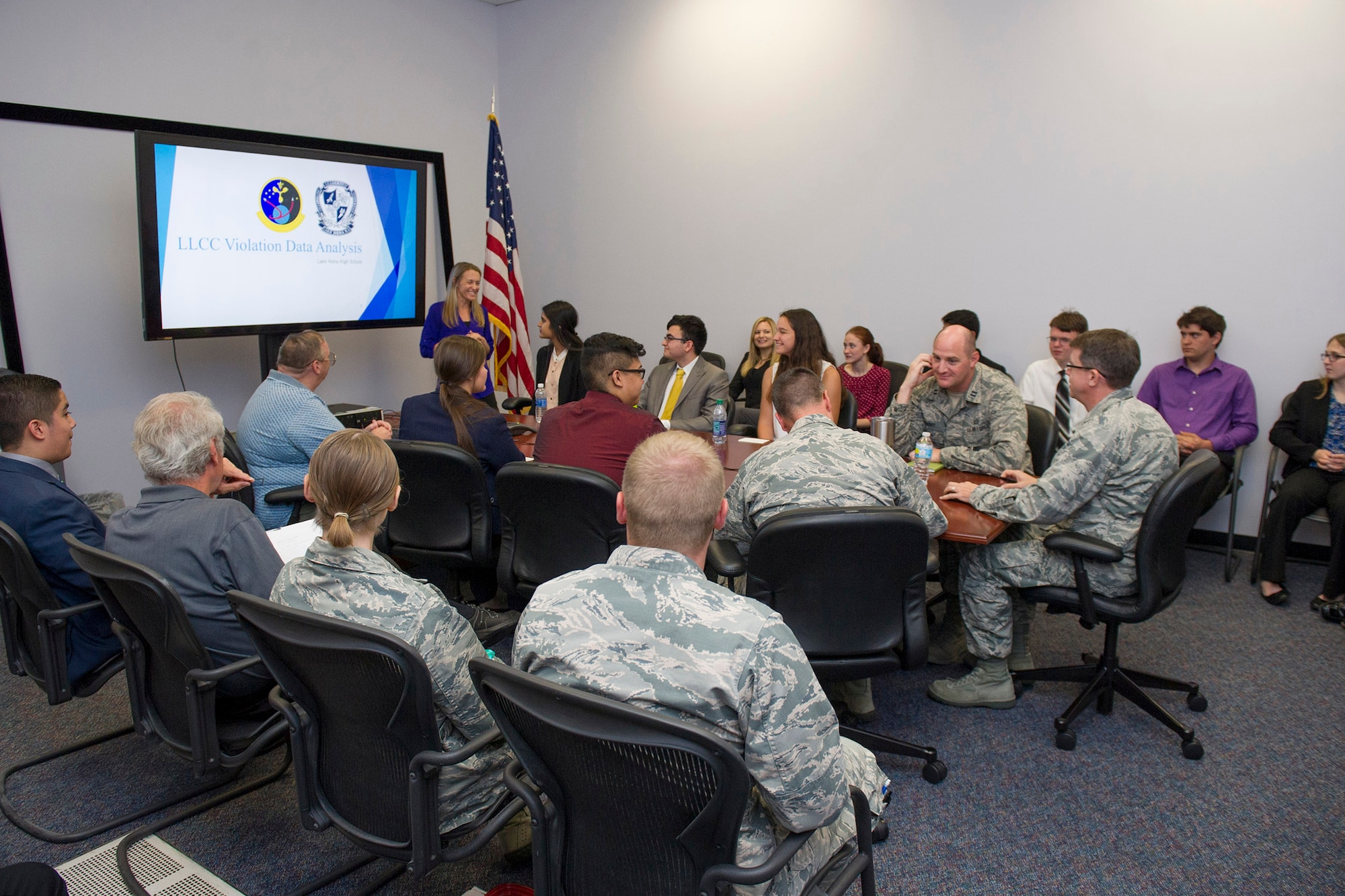 A Lake Nona High School student discusses her findings and results in regards to weather and climatology to members of the 45th Space Wing during a visit April 18, 2017, at Cape Canaveral Air Force Station, Fla. Prior to the school year, William Roeder, 45th Weather Squadron meteorologist, reached out to the high school and introduced them to the project. The project provides students with real-world experience by following a business model of preparation, set-up, and using innovative methods to complete it. (U.S. Air Force photo by Phil Sunkel)  