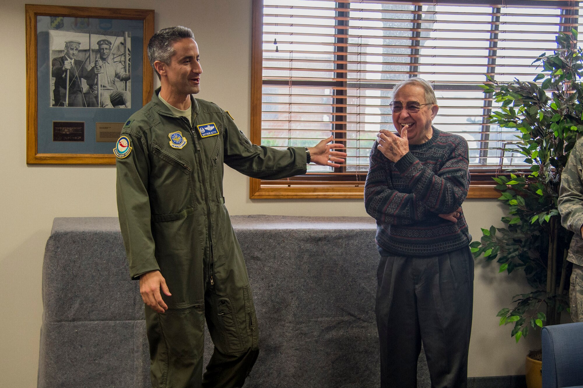 Lt. Col. Matt Getty speaks about Mr. Wayne Boller’s history with the Air Force during a dedication to Boller, April 11, at Scott Air Force Base’s Airfield Management Operations Atrium. The dedication was held to honor the donation of model aircraft that Boller made to the Base that are showcased in the Atrium. (U.S. Air Force photo by Airman Chad Gorecki)