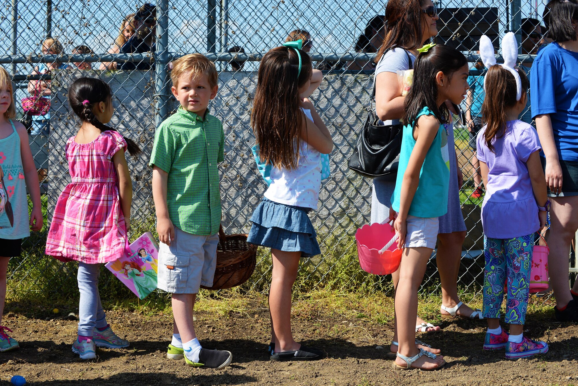 Egg hunters wait for the go ahead to collect as many eggs as they can at the Egg Hunt Egg-Stravaganza, Scott Air Force Base, Ill., April 15, 2017. The family friendly event was hosted by the 375th Force Support Squadron, and was full of games and activities for children 12 and under. (U.S. Air Force photo by Senior Airman Erica Fowler)