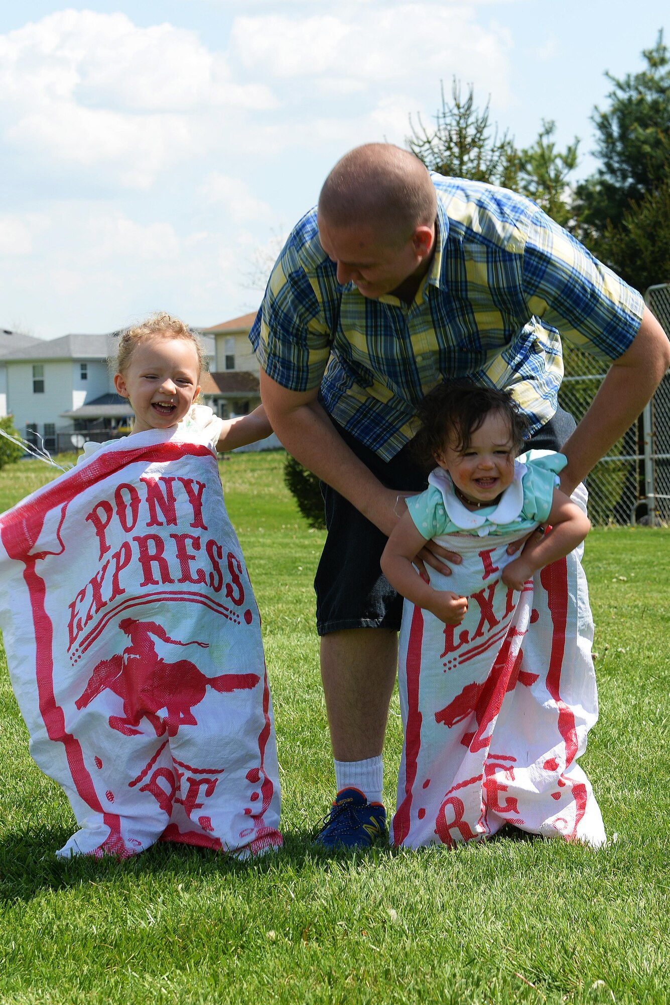 Team Scott families partake in many fun activities at the Egg Hunt Egg-Stravaganza, hosted by the 375th Force Support Squadron, Scott Air Force Base, Ill., April 15, 2017. The free event at the Scott AFB Youth Center included egg hunts for different age groups, Easter bunny, bounce houses, face painting, prizes, food from the USO, sack races, and a Security Forces vehicle display. (U.S. Air Force photo by Senior Airman Erica Fowler)