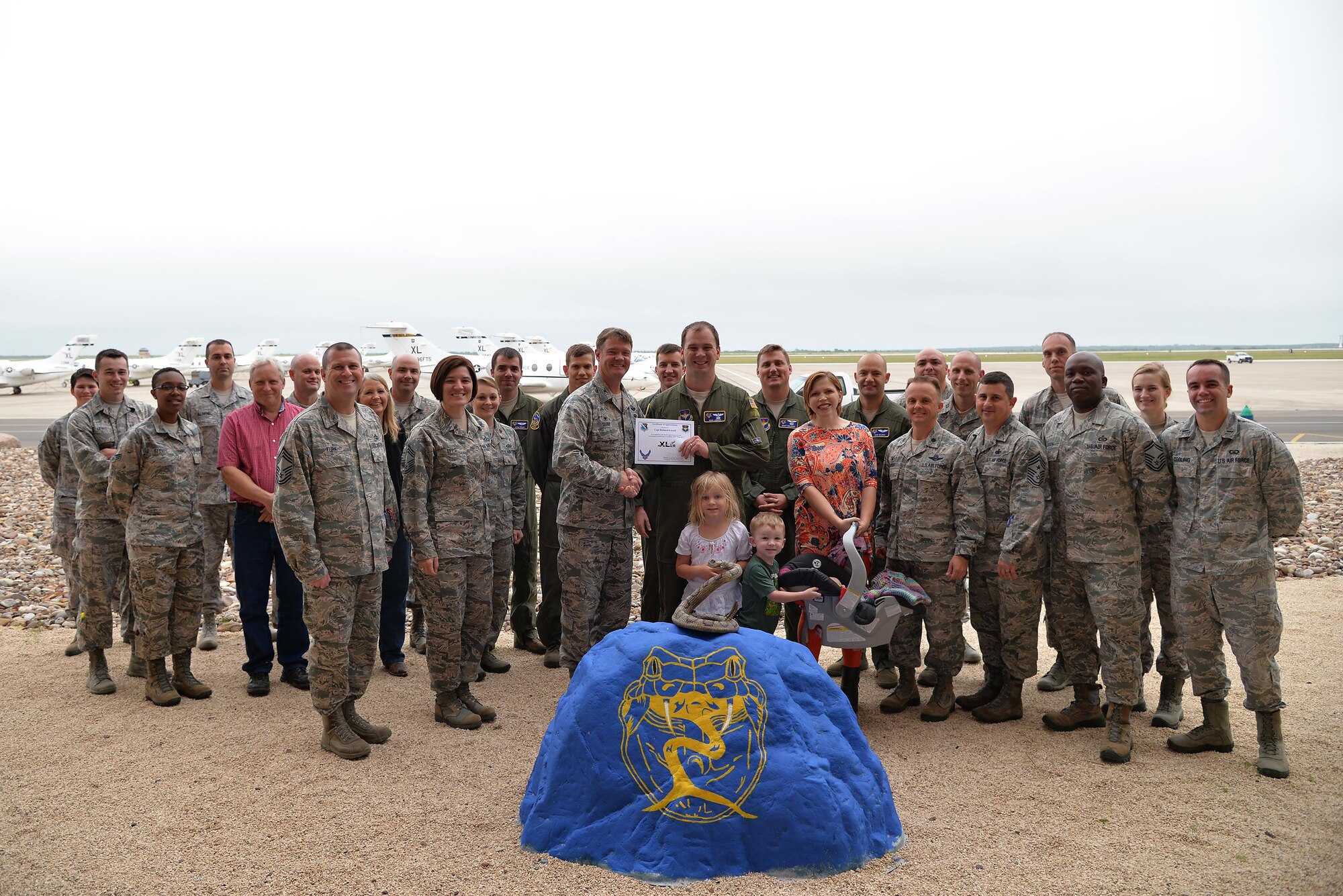 Capt. Richard Loesch, 47th Operations Support Squadron chief of wing airspace (center), accepts the “XLer of the Week” award from Col. Thomas Shank, 47th Flying Training Wing commander (left), and Chief Master Sgt. George Richey, 47th FTW command chief (right), on Laughlin Air Force Base, Texas, April 12, 2017. The XLer is a weekly award chosen by wing leadership and is presented to those who consistently make outstanding contributions to their unit and Laughlin. (U.S. Air Force photo/Airman 1st Class Daniel Hambor)