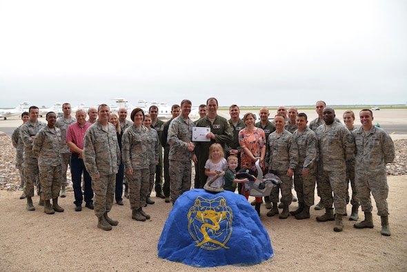 Capt. Richard Loesch, 47th Operations Support Squadron chief of wing airspace (center), accepts the “XLer of the Week” award from Col. Thomas Shank, 47th Flying Training Wing commander (left), and Chief Master Sgt. George Richey, 47th FTW command chief (right), on Laughlin Air Force Base, Texas, April 12, 2017. The XLer is a weekly award chosen by wing leadership and is presented to those who consistently make outstanding contributions to their unit and Laughlin. (U.S. Air Force photo/Airman 1st Class Daniel Hambor)