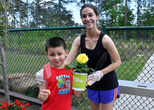 Kelley Lamberth and her son Ryan prepare to plant flowers at the Joint Base Charleston-Weapons Station Child Development Center, April 13, 2017. April was named Month of the Military Child by former Defense Secretary Casper Weinberger in 1989 to applaud military children for their daily sacrifices and the challenges they have overcome. The WS CDC is celebrating Month of the Military Child by hosting Wacky Hat Wednesdays, Purple Up! Fridays and planting gardens with parents and students.