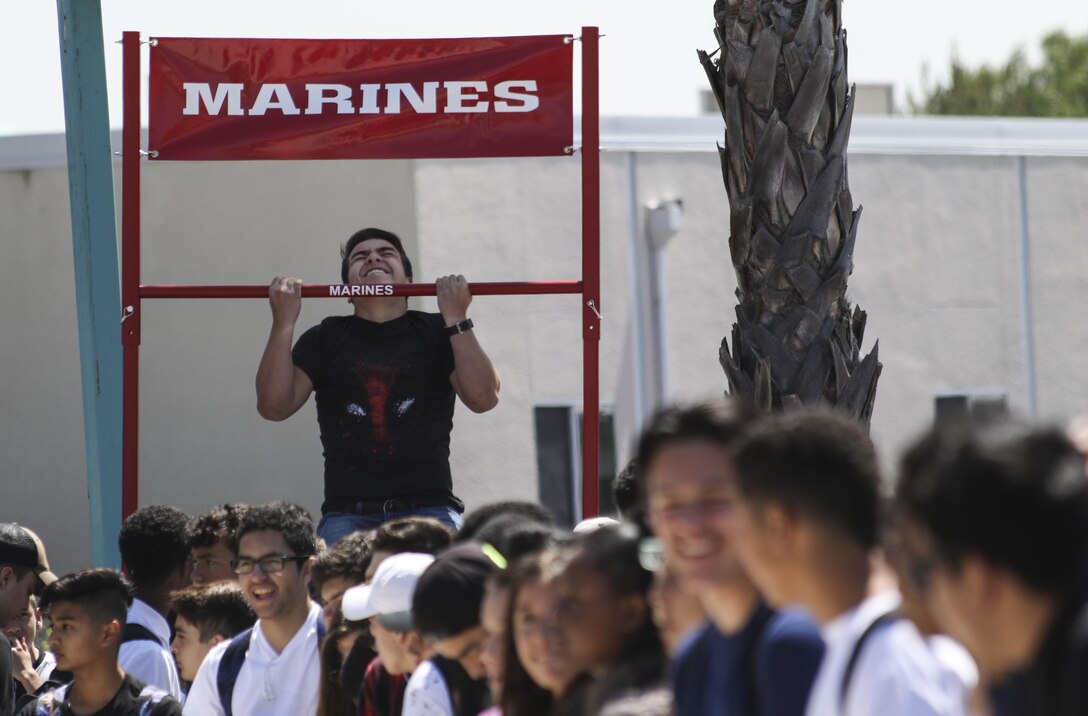 A student from Olympian High School, Chula Vista, California, executes as many pull-ups as he can to earn prizes from the pull-up challenge during the anti-bullying ASA tour, April 4, 2017. Marine Corps Recruiters from San Diego, ASA Entertainment staff and professional BMX riders traveled to multiple schools, April 3-7, 2017, to spread anti-bullying awareness and teach students how to prevent and react to different types of bullying. (U.S. Marine Corps photo by Sgt. William Hester/ Released)