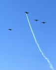 Four B-25 Mitchell bombers fly over the National Museum of the Air Force at Wright-Patterson Air Force Base, Ohio, April 18, 2017, in a missing-man formation on the 75th anniversary of the Doolittle Raid on Japan. The flyover marked the start of a memorial service commemorating the attack. (U.S. Air Force photo by R.J. Oriez)