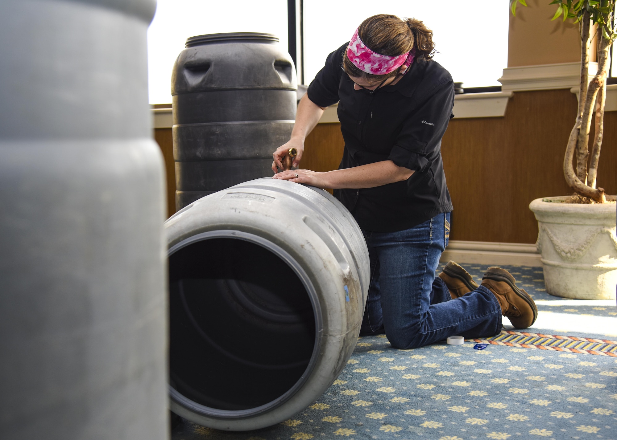 Alicia Garcia, 633rd Civil Engineer Squadron environmental flight Natural Resource Program manager, screws a tap into a rain barrel during a rain harvesting workshop at Joint Base Langley-Eustis, Va., April 17, 2017. According to Dawn Christian, 633rd Civil Engineer Squadron environmental flight water program manager, just one inch of rain on a 1,200 sq. ft. roof equals 748 gallons of free water for plants, lawns and bird baths. (U.S. Air Force photo/Airman 1st Class Anthony Nin Leclerec)