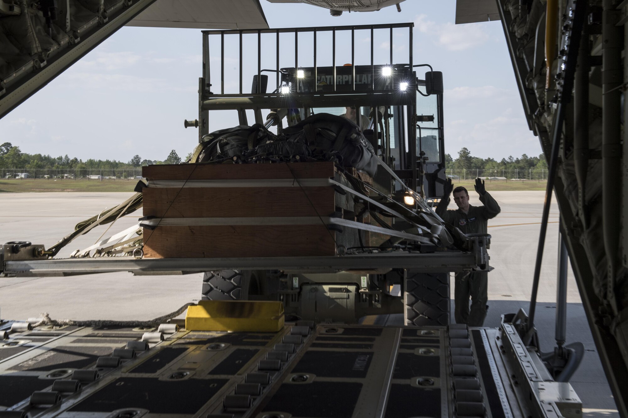 Staff Sgt. Josh Noethe, 71st Rescue Squadron loadmaster, guides a training bundle into the back of an HC-130J Combat King II, April 18, 2017, at Moody Air Force Base, Ga. The training bundle weighed approximately 3,000 pounds and is designed to simulate a heavy equipment air drop. This training helps the 71st RQS remain ready to provide rapidly deployable, expeditionary personnel recovery forces to theater commanders for contingency response operations worldwide. (U.S. Air Force photo by Tech. Sgt. Zachary Wolf)