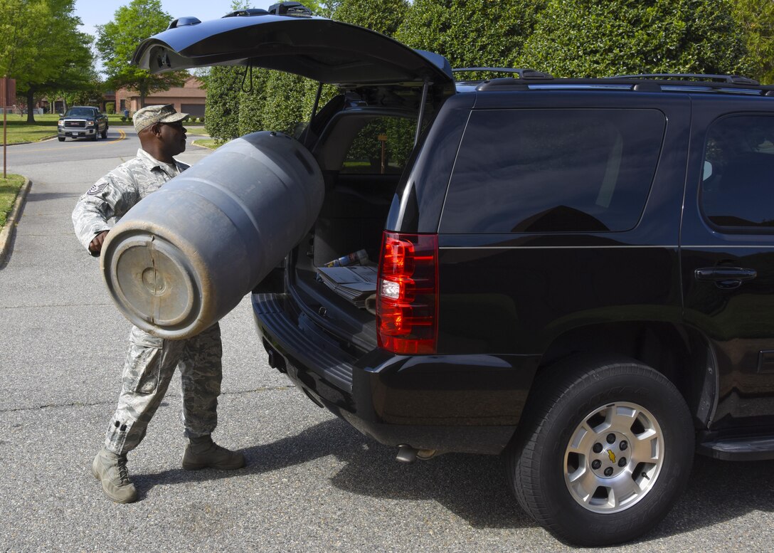 U.S. Air Force Tech. Sgt. Mark Hill, 710th Combat Operations Squadron member, loads his rain barrel after a rain harvesting workshop at Joint Base Langley-Eustis, Va., April 17, 2017. According to Dawn Christian, 633rd Civil Engineer Squadron environmental flight water program manager, the phosphorous and nitrogen found in rain water will provide better nutrition to plants than water from a sprinkler. (U.S. Air Force photo/Airman 1st Class Anthony Nin Leclerec)