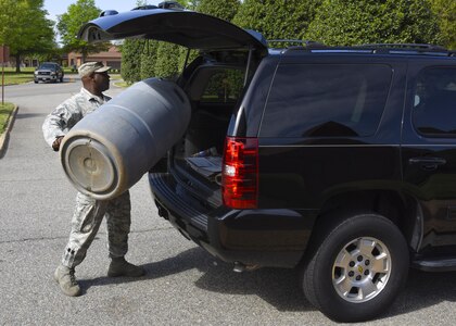 U.S. Air Force Tech. Sgt. Mark Hill, 710th Combat Operations Squadron member, loads his rain barrel after a rain harvesting workshop at Joint Base Langley-Eustis, Va., April 17, 2017. According to Dawn Christian, 633rd Civil Engineer Squadron environmental flight water program manager, the phosphorous and nitrogen found in rain water will provide better nutrition to plants than water from a sprinkler. (U.S. Air Force photo/Airman 1st Class Anthony Nin Leclerec)