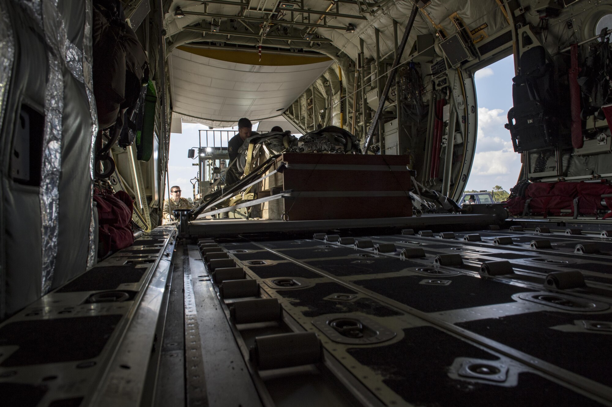 Loadmasters from the 71st Rescue Squadron secure a training bundle in an HC-130J Combat King II, April 18, 2017, at Moody Air Force Base, Ga. The training bundle weighed approximately 3,000 pounds and is designed to simulate a heavy equipment air drop. This training helps the 71st RQS remain ready to provide rapidly deployable, expeditionary personnel recovery forces to theater commanders for contingency response operations worldwide. (U.S. Air Force photo by Tech. Sgt. Zachary Wolf)