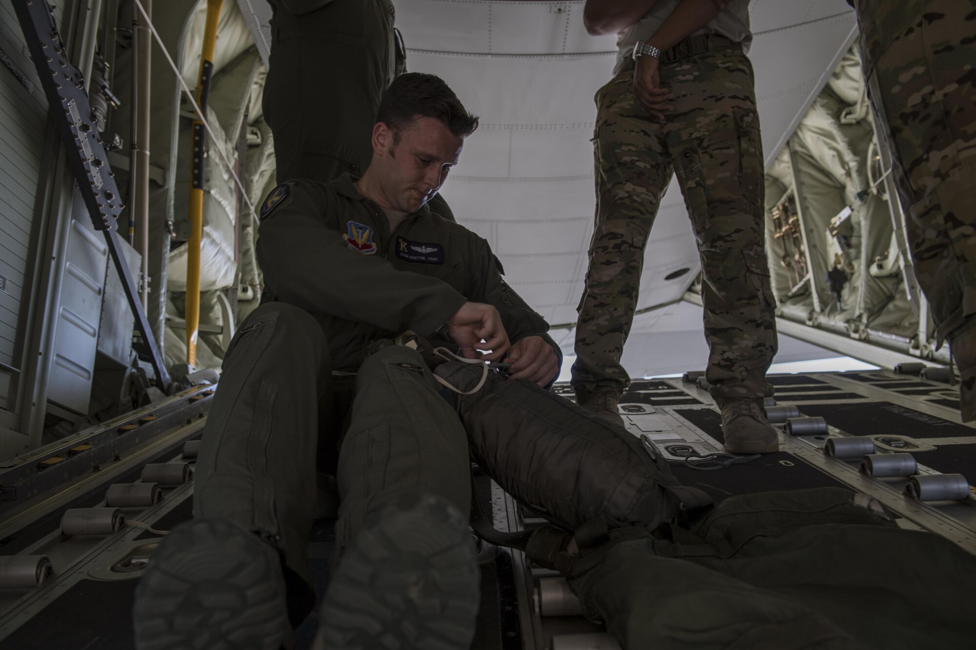 Staff Sgt. Josh Noethe, 71st Rescue Squadron loadmaster, checks a parachute on a training bundle, April 18, 2017, at Moody Air Force Base, Ga. The training bundle weighed approximately 3,000 pounds and is designed to simulate a heavy equipment air drop. This training helps the 71st RQS remain ready to provide rapidly deployable, expeditionary personnel recovery forces to theater commanders for contingency response operations worldwide. (U.S. Air Force photo by Tech. Sgt. Zachary Wolf)