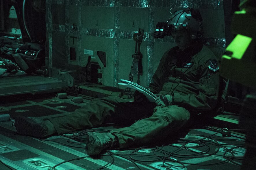 Staff Sgt. Josh Noethe, 71st Rescue Squadron loadmaster, reviews a checklist while on an HC-130J Combat King II, April 18, 2017, at Moody Air Force Base, Ga. Noethe reviewed the procedures to drop a training bundle weighing approximately 3,000 pounds which was designed to simulate a heavy equipment air drop. This training helps the 71st RQS remain ready to provide rapidly deployable, expeditionary personnel recovery forces to theater commanders for contingency response operations worldwide. (U.S. Air Force photo by Tech. Sgt. Zachary Wolf)