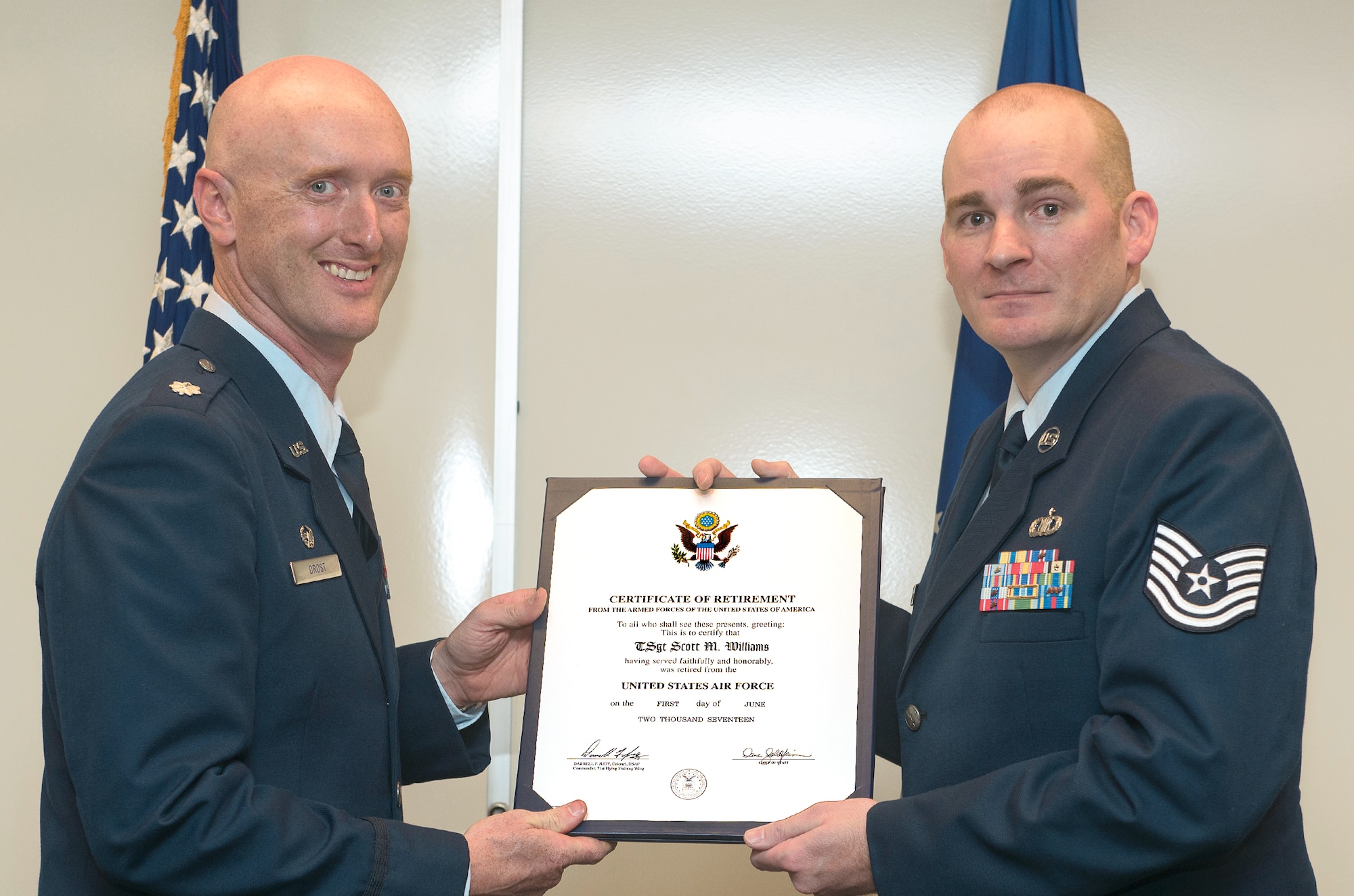 Tech. Sgt. Scott Williams, right, receives his certificate of Air Force retirement from Lt. Col. Michael Drost, 71st Operations Support Squadron, during a ceremony held April 14 at Vance Air Force Base, Oklahoma. (U.S. Air Force photo/ Terry Wasson)