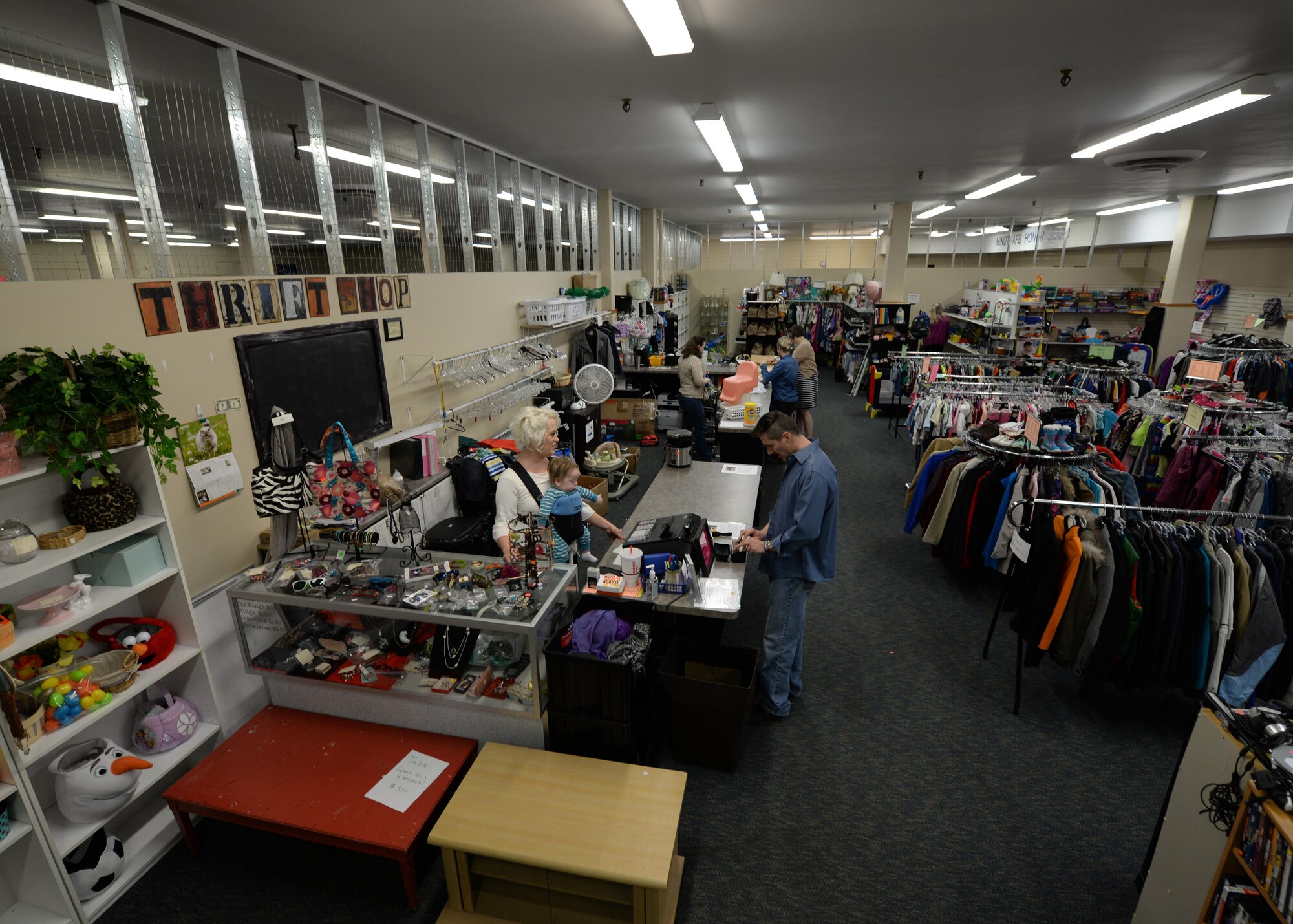 Thrift shop volunteers assist customers at Minot Air Force Base, N.D., April 7, 2017.  All profits made at the thrift shop go to multiple charities that help the community. (U.S. Air Force photo/ Airman 1st Class Dillon J. Audit)