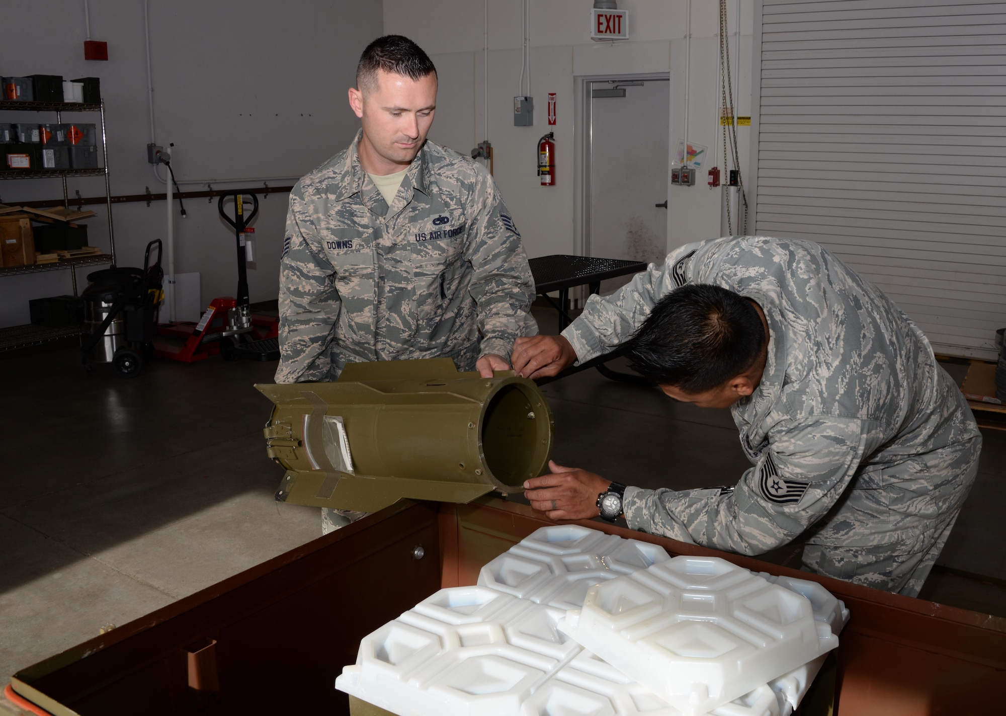Staff Sgt. Philip Downs (Left) and Tech. Sgt. Anthony Castillo (Right), both members of the 60th Maintenance Squadron, inspect a bomb tail fin at Travis Air Force Base, Calif., April 5, 2017. Castillo and Downs are part of the maintenance squadron's munitions team responsible for munitions valued at over $13 million. (U.S. Air Force photo/Tech. Sgt. James Hodgman/Released)