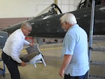 Jimmy Pulido, left, 12th Flying Training Wing maintenance egress supervisor and Michael LoBue, egress technician, prepare to install a foldable seat on a T-38 aircraft, April 17, 2017. 