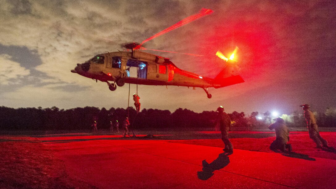 Sailors fast-rope from an MH-60S Seahawk helicopter during training for rope-suspension techniques at Joint Expeditionary Base Fort Story in Virginia Beach, Va., April 12, 2017. The seaman are assigned to Explosive Ordnance Disposal Group 2. Navy photo by Petty Officer 2nd Class Charles Oki