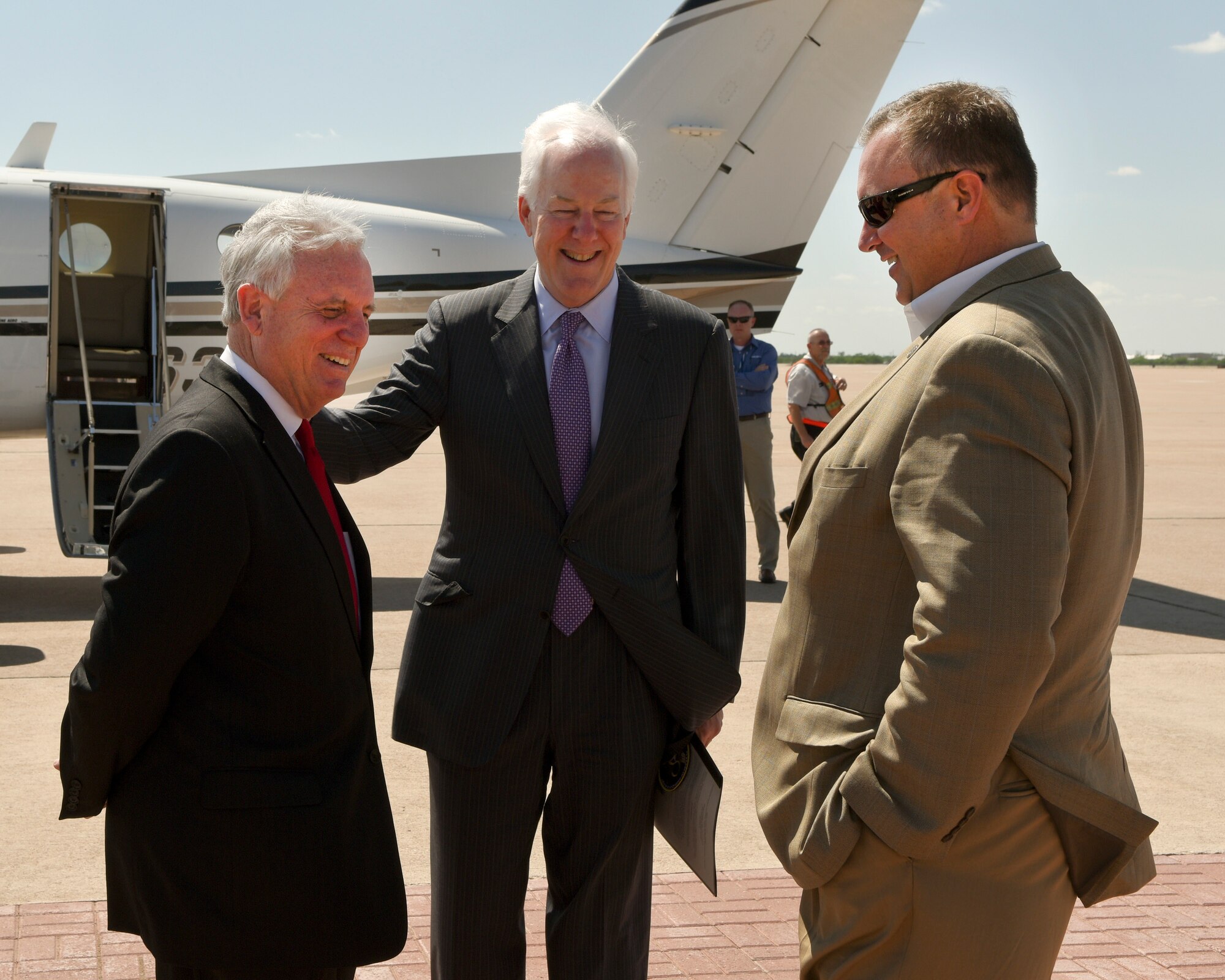 U.S. Sen. John Cornyn, R-TX, center, shares a laugh with Abilene Mayor Norm Archibald, left, and Doug Peters, president and CEO of the Abilene Chamber of Commerce, at Dyess Air Force Base, April 18, 2017. Abilene community leaders attended the tour in support of Dyess. (U.S. Air Force photo by Senior Airman Kedesha Pennant)