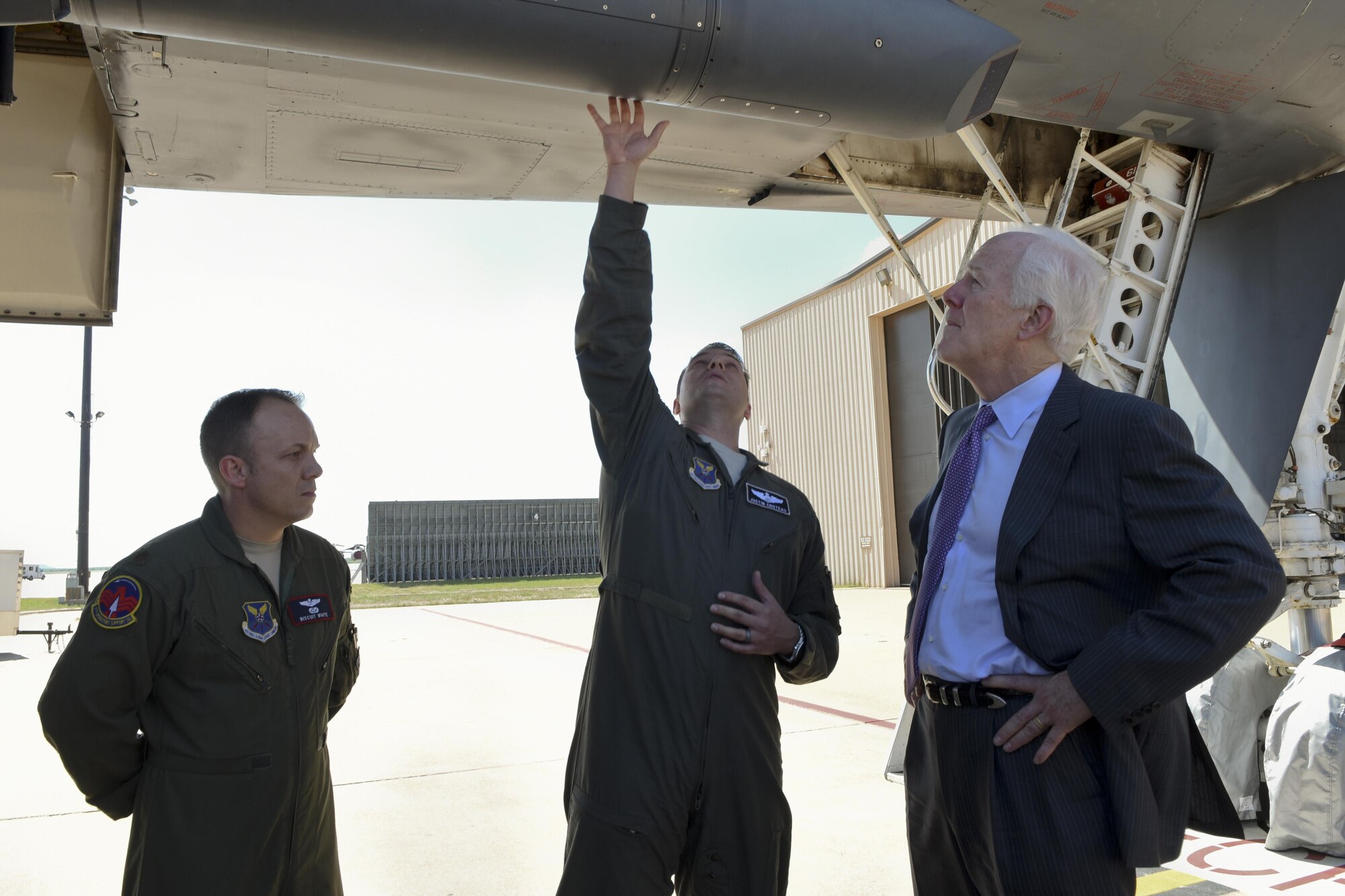 U.S. Air Force Maj. Justin Croteau, 9th Bomb Squadron chief of mobility, and Maj. Thomas White, 7th Operations Support Squadron assistant director of operations, explain the function of the B-1B Lancer navigation module to Sen. John Cornyn, R-TX, at Dyess Air Force Base, Texas, April 18, 2017. The senator was able to get an up-close look at the bomber and learn about its mission. (U.S. Air Force photo by Senior Airman Kedesha Pennant)