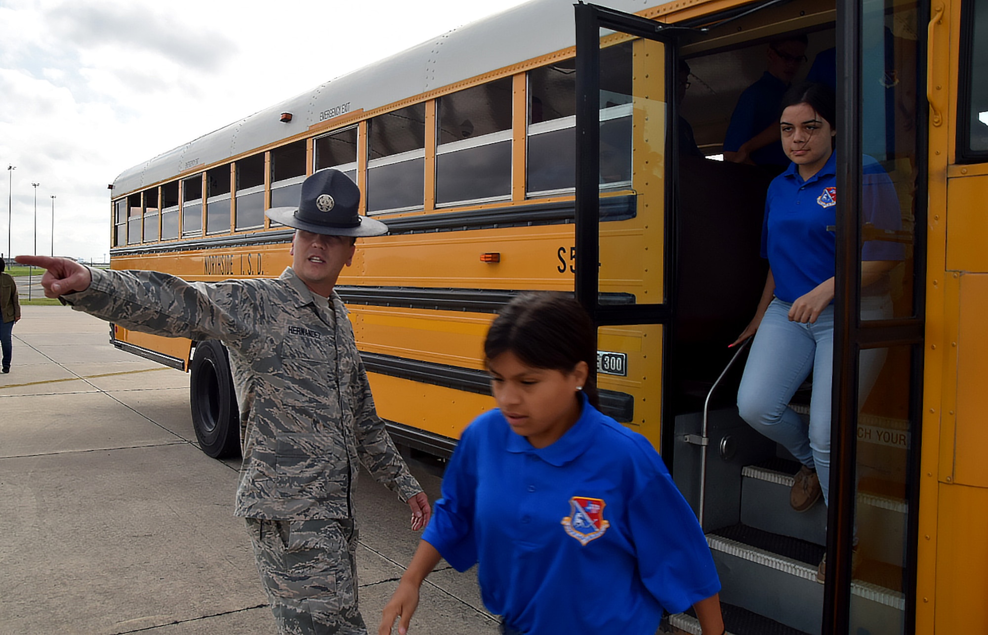 John Jay High School Air Force Junior Reserve Officer Training Corp students are directed off the bus by Tech. Sgt. Jason Hernandez, a 433rd Training Squadron military training instructor, April 19, 2017 at Joint Base San Antonio-Lackland, Texas. The students toured the engine, and structural engineering shops at the 433rd Airlift Wing and also saw a Military Working Dog demonstration at the 802nd Security Force Squadron. (U.S. Air Force photo by Tech. Sgt. Carlos J. Trevino) (released)