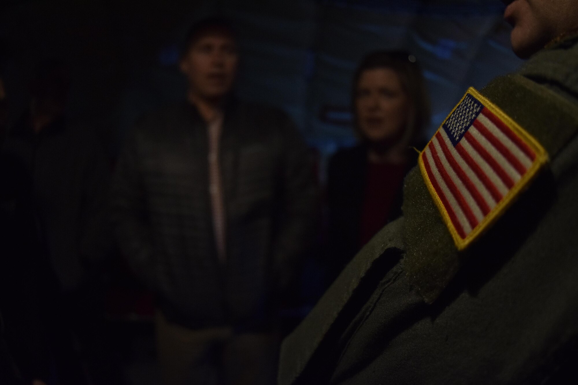 the American flag is in sharp focus on the shoulder of a member of the 507th Air Refueling Wing, Air Force Reserve Command, during a mission briefing aboard a KC-135R Stratotanker for the Tinker Air Force Base Honorary Commander's 2017 Class April 6, 2017, Tinker Air Force Base, Oklahoma. The Honorary Commander's learned about the KC-135R Stratotanker's mission during an air refueling mission with F-16s of the 138th Fighter Wing, Oklahoma Air National Guard. (U.S. Air Force photo/Greg L. Davis)