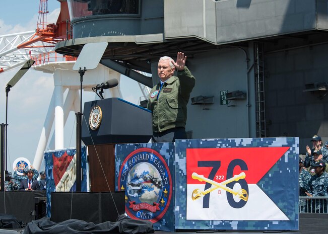 Vice President Michael R. Pence waves to service members on the flight deck of the Navy's forward-deployed aircraft carrier, USS Ronald Reagan (CVN 76), April 19, 2017. The vice president's tour of the ship and his remarks to U.S. and Japanese service members highlighted the administration's continuing commitment to rebuilding the U.S. military and to its alliances in the region. Ronald Reagan, the flagship of Carrier Strike Group 5, provides a combat-ready force that protects and defends the collective maritime interests of its allies and partners in the Indo-Asia-Pacific region.