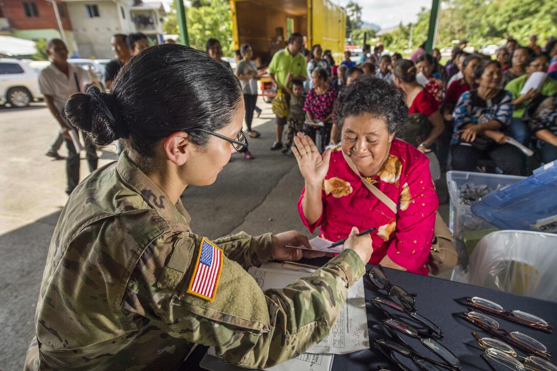 Army Capt. Frances Silva gives an eye exam during a community health engagement at Suba Buan Bau for Pacific Partnership 2017 in Kuching, Malaysia, April 19, 2017.The humanitarian assistance and disaster relief preparedness mission aims to enhance regional coordination in areas such as medical readiness and preparedness for manmade and natural disasters. Navy photo by Petty Officer 2nd Class Chelsea Troy Milburn