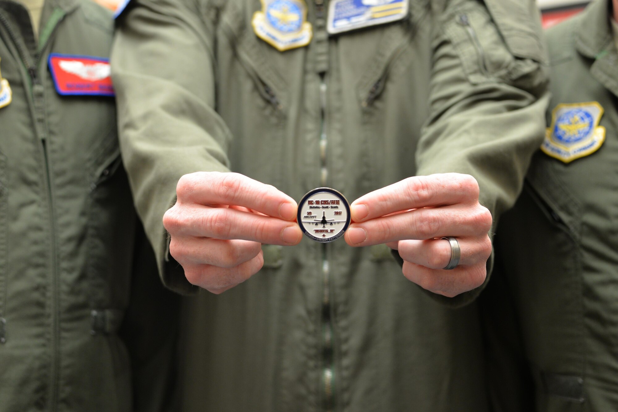 The aircrew who completed the final KC-10 Extender modification flight displays the coin they received to signify the completion of the project April 5 at Travis Air Force Base, California. The 59th and final KC-10 was modified and flown home by the 9th and 6th Air Refueling Squadrons at Travis March 28. (U.S. Air Force photo / 2nd Lt. Sarah Johnson)

