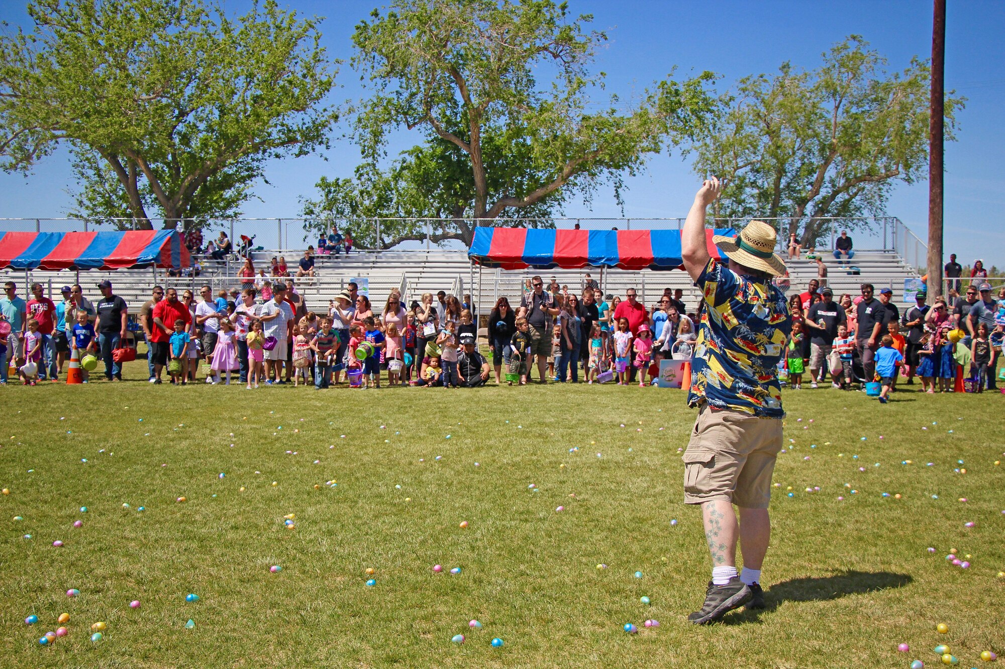 Edison Ruland, 412th FSS Community Activities director, prepares to give the starting order to a group of children to begin their Easter egg hunt at Wings and Roberts Fields April 15. A total of 8,000 prize-filled eggs were collected. (U.S. Air Force photo by Kayla Fagan)