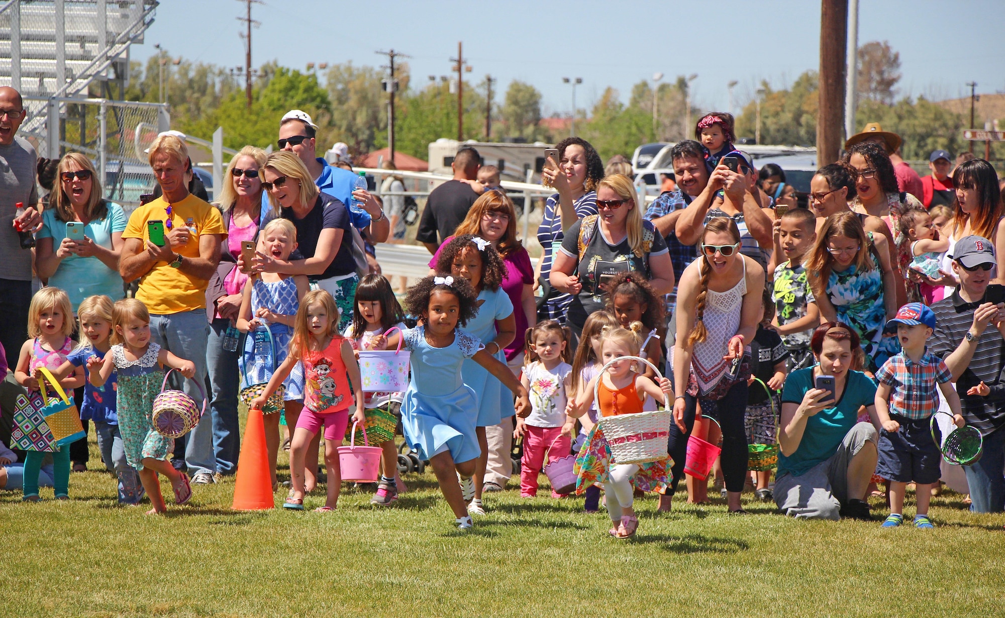 About 500 children were divided into five different age groups for the Easter Egg-stravaganza held April 15. Each group patiently waited their turn to run out on Wings and Roberts Fields and fill their baskets with candy-filled eggs – one of which had a ticket for a three-pound chocolate bunny. After all 8,000 eggs were collected, families stayed to enjoy complimentary hot dogs and cupcakes and enjoy the beautiful sunshine before the next event began. (U.S. Air Force photo by Kayla Fagan)