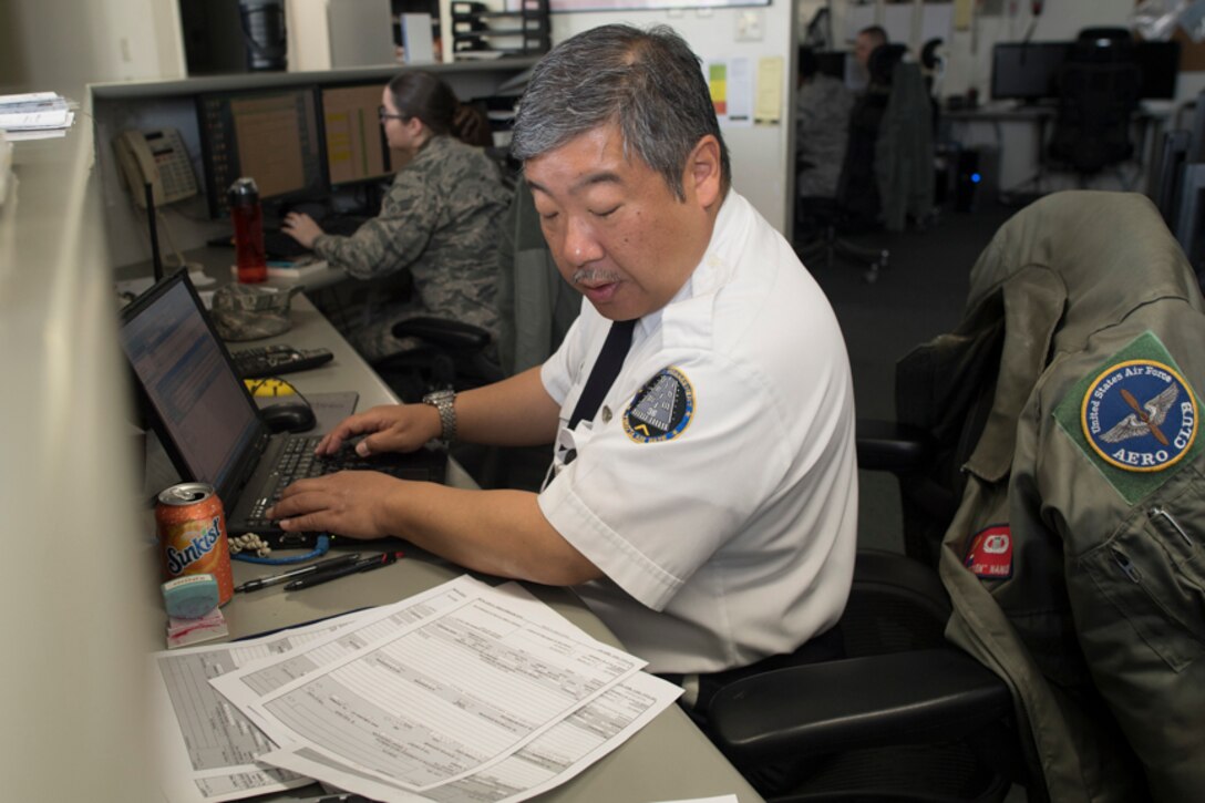 Keita Nanko, 374th Operations Support Squadron air traffic specialist, inputs flight plans at Yokota Air Base, Japan, during the Kanto Plain Mid-Air Collision and Avoidance Conference, April 15, 2017. . Twenty-five airmen and civilian volunteered to help the conference by helping coordinate tours, drivers, air marshals, check-in, briefers and flight plan checks. (U.S. Air Force photo by Yasuo Osakabe)