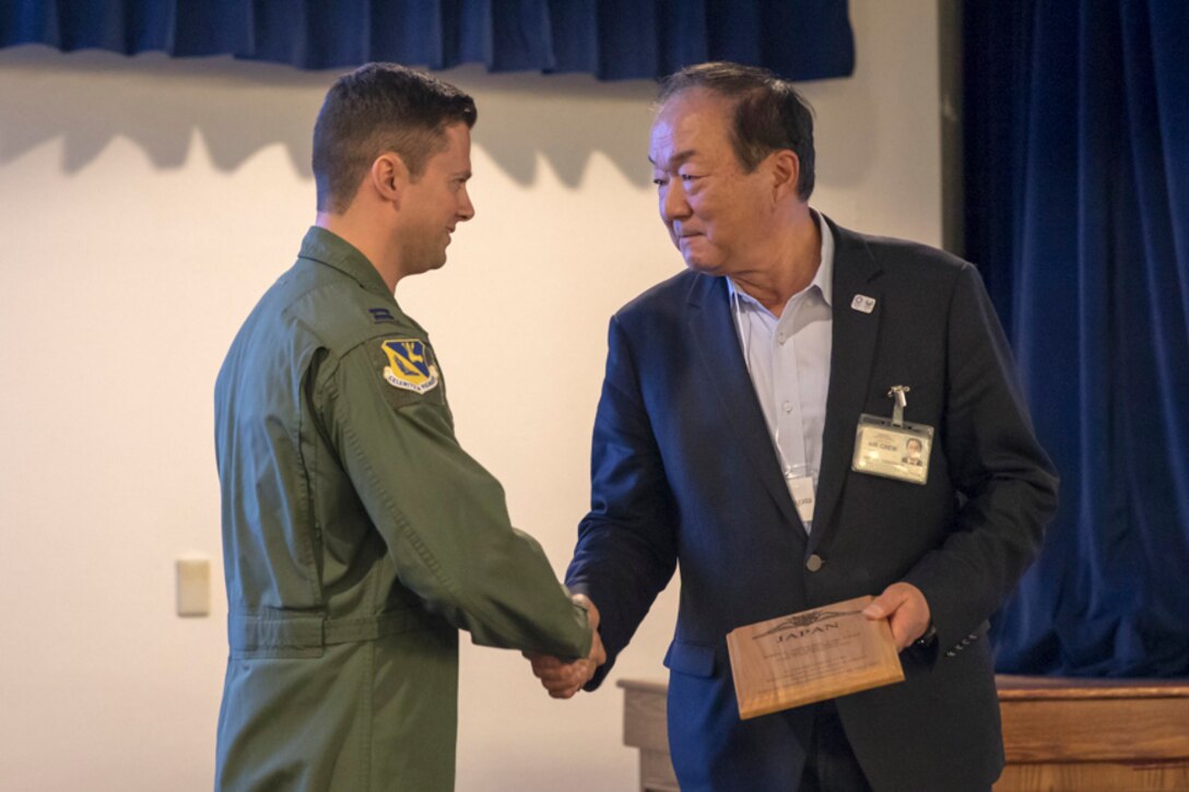Arinori Yamagata, the Aircraft Owners and Pilots Association-Japan, shakes hands with Capt. John Menezes, 374th Airlift Wing flight safety officer, during the Kanto Plain Mid-Air Collision and Avoidance Conference, at Yokota Air Base, Japan, April 15, 2017. More than 100 private Japanese pilots participated in the conference to increase awareness and promote safety in the skies over the Yokota and the surrounding communities. (U.S. Air Force photo by Yasuo Osakabe)
