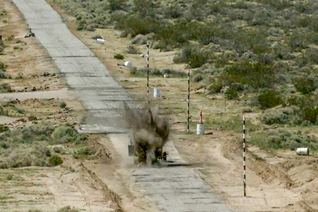 A GBU-12 Paveway II guided bomb engages a computer-driven small pickup truck during a test at Naval Air Weapons Station China Lake, California. The inert bomb was dropped from an Edwards F-35C. (Image courtesy of Lockheed Martin)