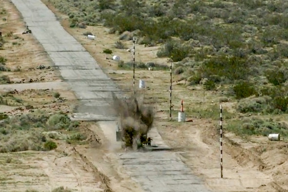 A GBU-12 Paveway II guided bomb engages a computer-driven small pickup truck during a test at Naval Air Weapons Station China Lake, California March 29. The inert bomb was dropped from an Edwards F-35C. (Image courtesy of Lockheed Martin)
