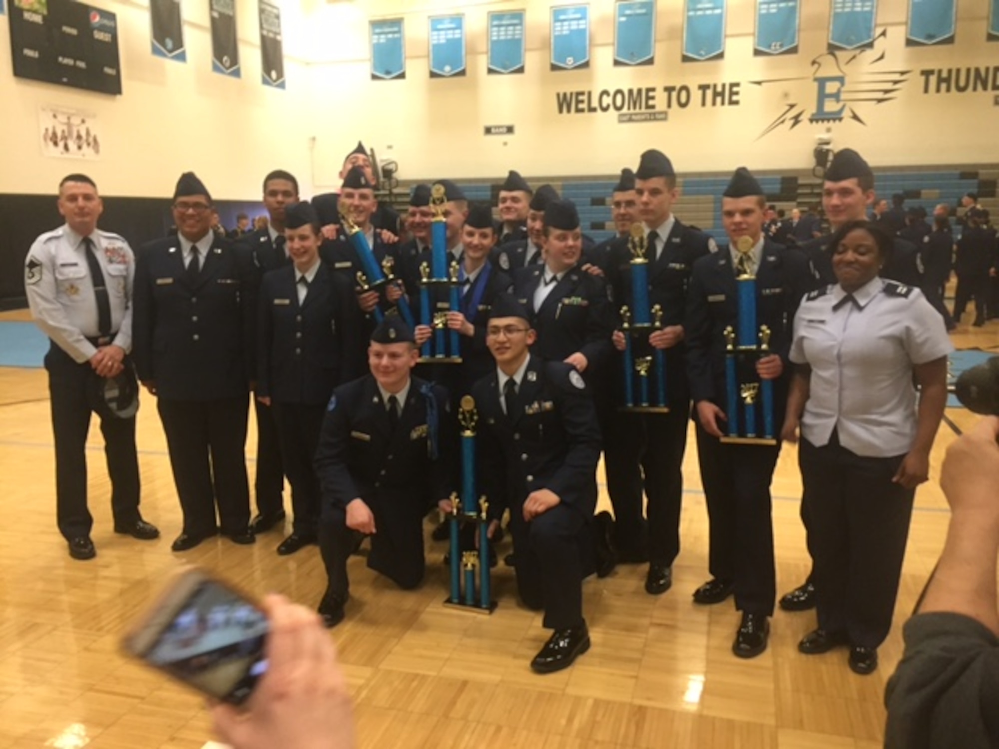 Master Sgt. Doumit Elias, 90th Missile Security Forces Squadron chief of standards and evaluations, far left, stands with the East High School Air Force Junior ROTC honor guard drill team during a competition in Cheyenne, Wyo., March 18, 2017. The East High School team took home four trophies including best overall honor guard team. (U.S. Air Force courtesy photo)