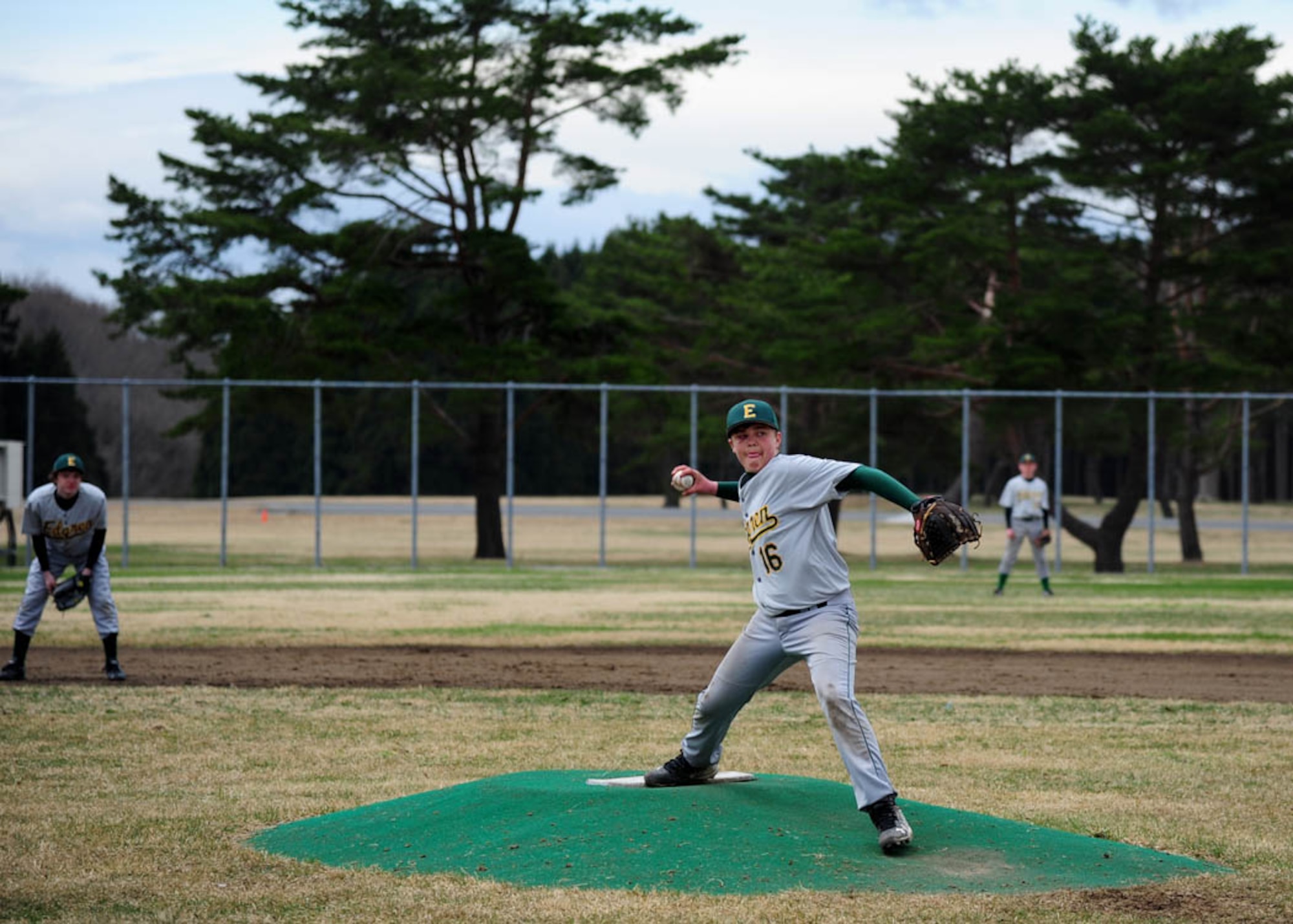 Ethan, son of Master Sgt. Brian Barry, 35th Civil Engineer Squadron facilities superintendent, pitches a ball to the opposing team as his teammates anticipate the upcoming play during the second game of the weekend at Misawa Air Base, Japan, April 15, 2017. During the first game the team watched as Ethan got hit in the face with a high-speed baseball. They didn’t except him to pitch the second game, but without hesitation Ethan showed up ready to play. (U.S. Air Force photo by Tech. Sgt. April Quintanilla)
