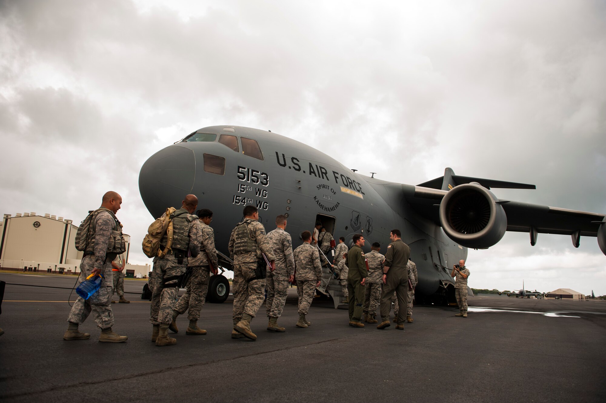 Airmen board a C-17 Globemaster III headed to Wheeler Army Airfield, Hawaii for Exercise TROPIC THUNDER 2017 (XTT17), Joint Base Pearl Harbor-Hickam, Hawaii, April 19, 2017. XTT17 is a two part full spectrum readiness exercise hosted by the 15th Wing to test the individual, organizational and expeditionary readiness of the Airmen stationed at Hickam Field. (U.S. Air Force photo by Tech. Sgt. Heather Redman)