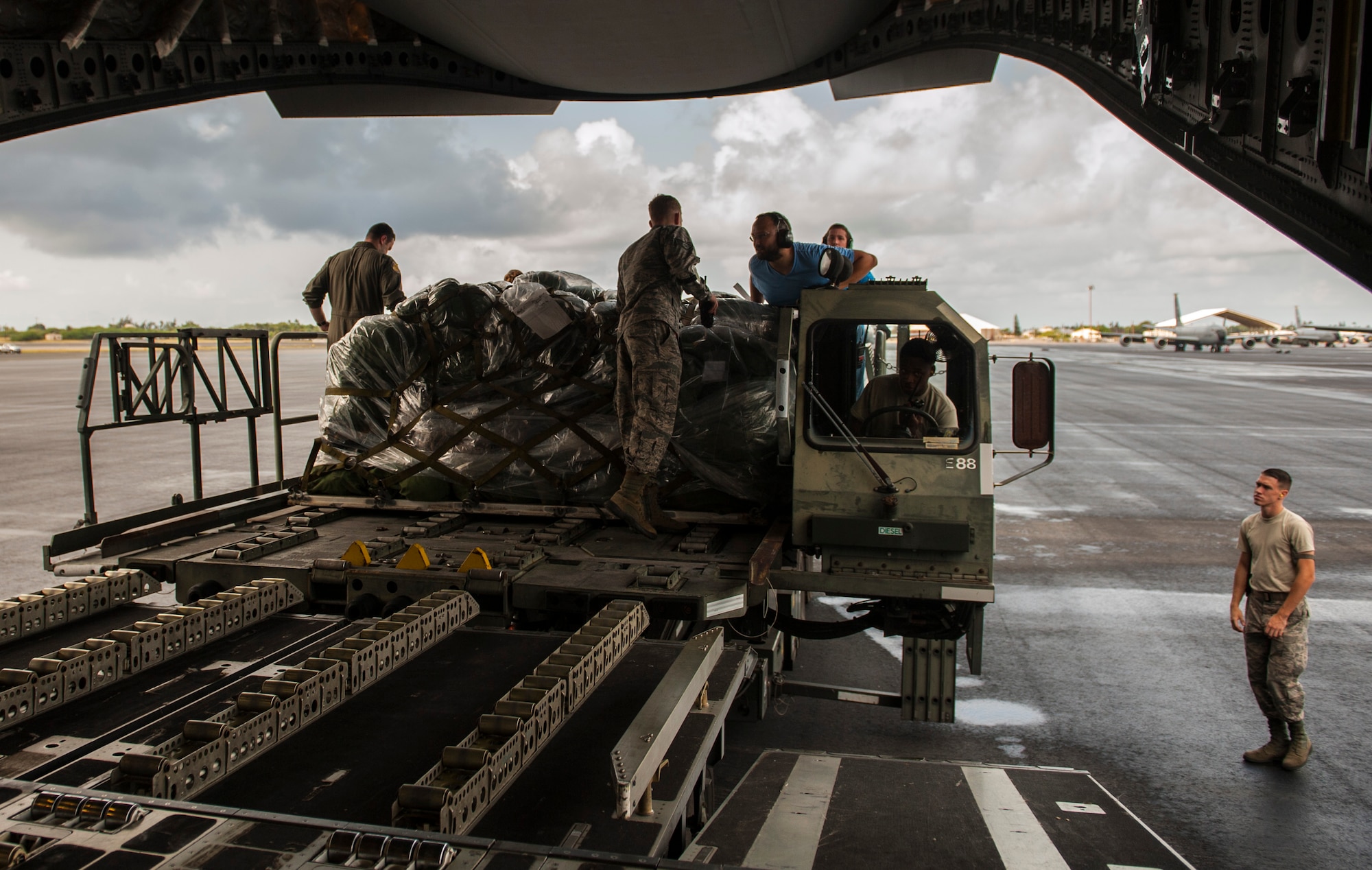 Logistics personnel work together to load cargo onto a C-17 Globemaster III during Exercise TROPIC THUNDER 2017 (XTT17), Joint Base Pearl Harbor-Hickam, Hawaii, April 19,2017. XTT17 is a two part full spectrum readiness exercise hosted by the 15th Wing to test the individual, organizational and expeditionary readiness of the Airmen stationed at Hickam Field. (U.S. Air Force photo by Tech. Sgt. Heather Redman)