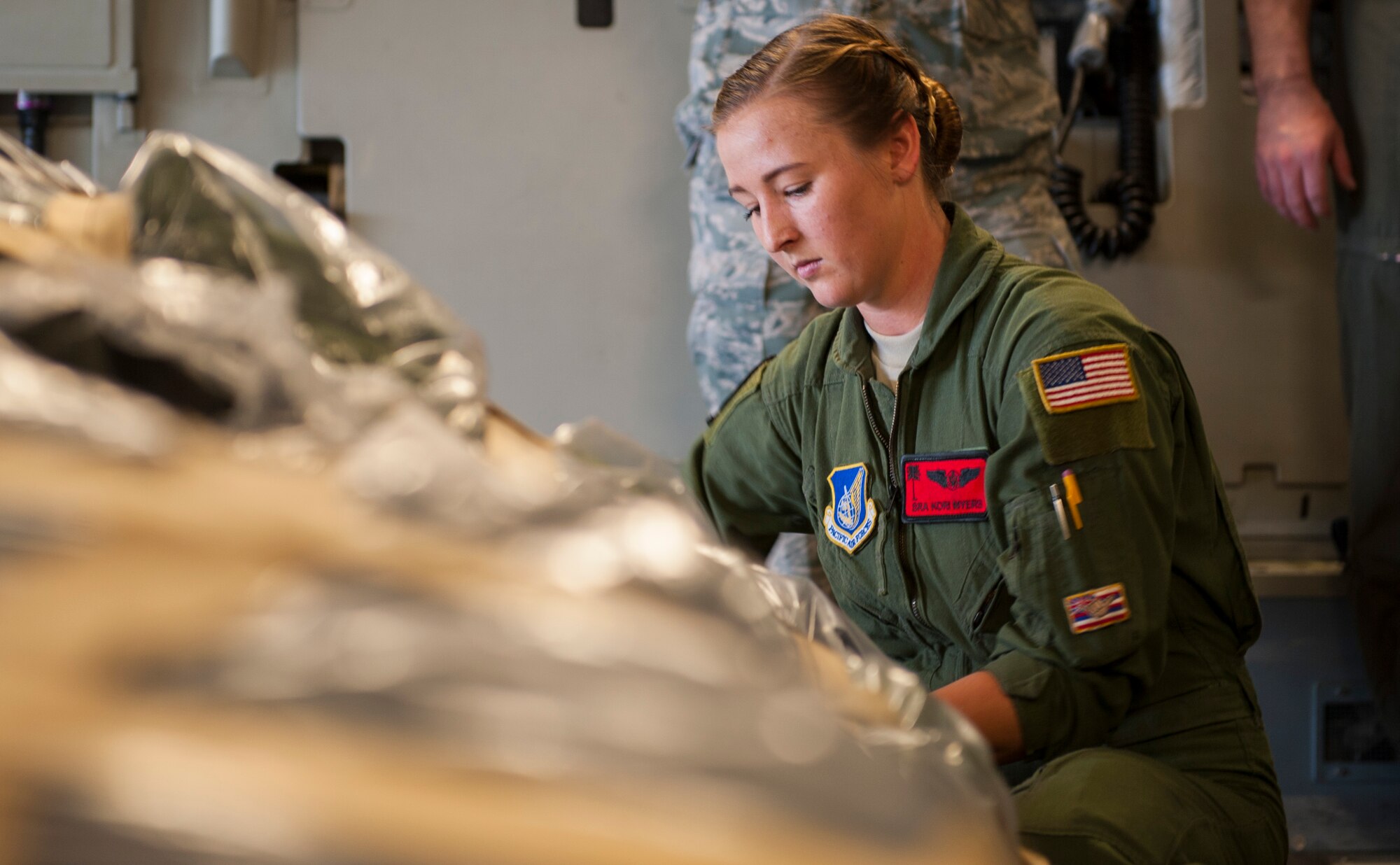 Senior Airman Korina Myers, loadmaster assigned to the 535th Airlift Squadron, secures cargo straps on a C-17 Globemaster III during Exercise TROPIC THUNDER 2017 (XTT17), Joint Base Pearl Harbor-Hickam, Hawaii, April 19,2017. XTT17 is a two part full spectrum readiness exercise hosted by the 15th Wing to test the individual, organizational and expeditionary readiness of the Airmen stationed at Hickam Field. (U.S. Air Force photo by Tech. Sgt. Heather Redman)