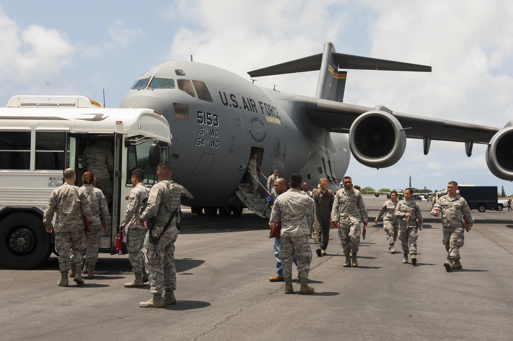 Airmen disembark a C-17 Globemaster III and load onto a bus headed for Wheeler Army Airfield on Joint Base Pearl Harbor-Hickam, Hawaii, April 19, 2017. The C-17 was headed to Wheeler for Exercise TROPIC THUNDER 2017 (XTT17) but was diverted due to weather.  XTT17 is a two part full spectrum readiness exercise hosted by the 15th Wing to test the individual, organizational and expeditionary readiness of the Airmen stationed at Hickam Field. (U.S. Air Force photo by Tech. Sgt. Heather Redman)