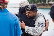 U.S. Air Force Tech. Sgt. Oswaldo Cerrato, 18th Security Forces Squadron flight lead, thanks U.S. Air Force retired Master Sgt. David Lacar for his efforts in the rescue of a dwarf sperm whale April 17, 2017, at Kadena Marina, Japan. Lacar aided in the rescue effort for the whale after Okinawan fishermen spotted the whale and called for help. (U.S. Air Force photo by Senior Airman Omari Bernard/Released)